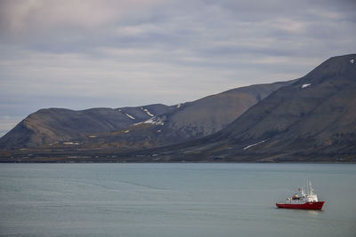 Sailboat in sea against sky