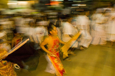 People in illuminated water at night