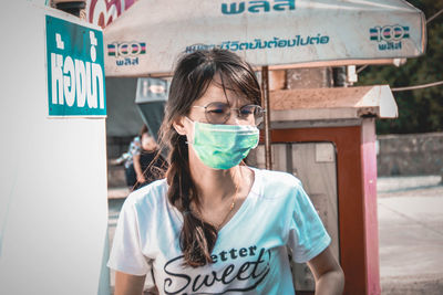 Portrait of a young woman standing outdoors