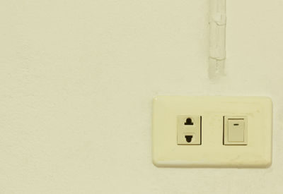 Close-up of electric lamp on wall