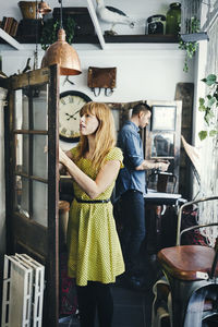 Woman standing by window in store