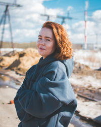 Portrait of smiling woman standing on land