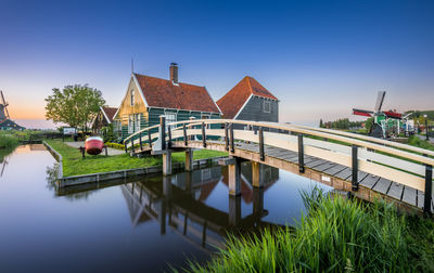 View of footbridge over pond by house