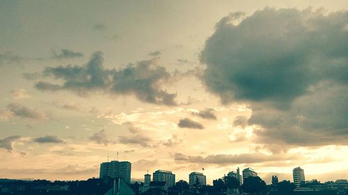 Cityscape against cloudy sky