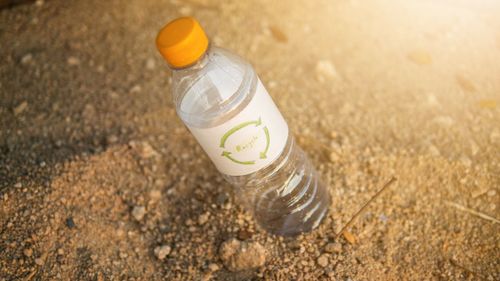 High angle view of drink in glass on sand