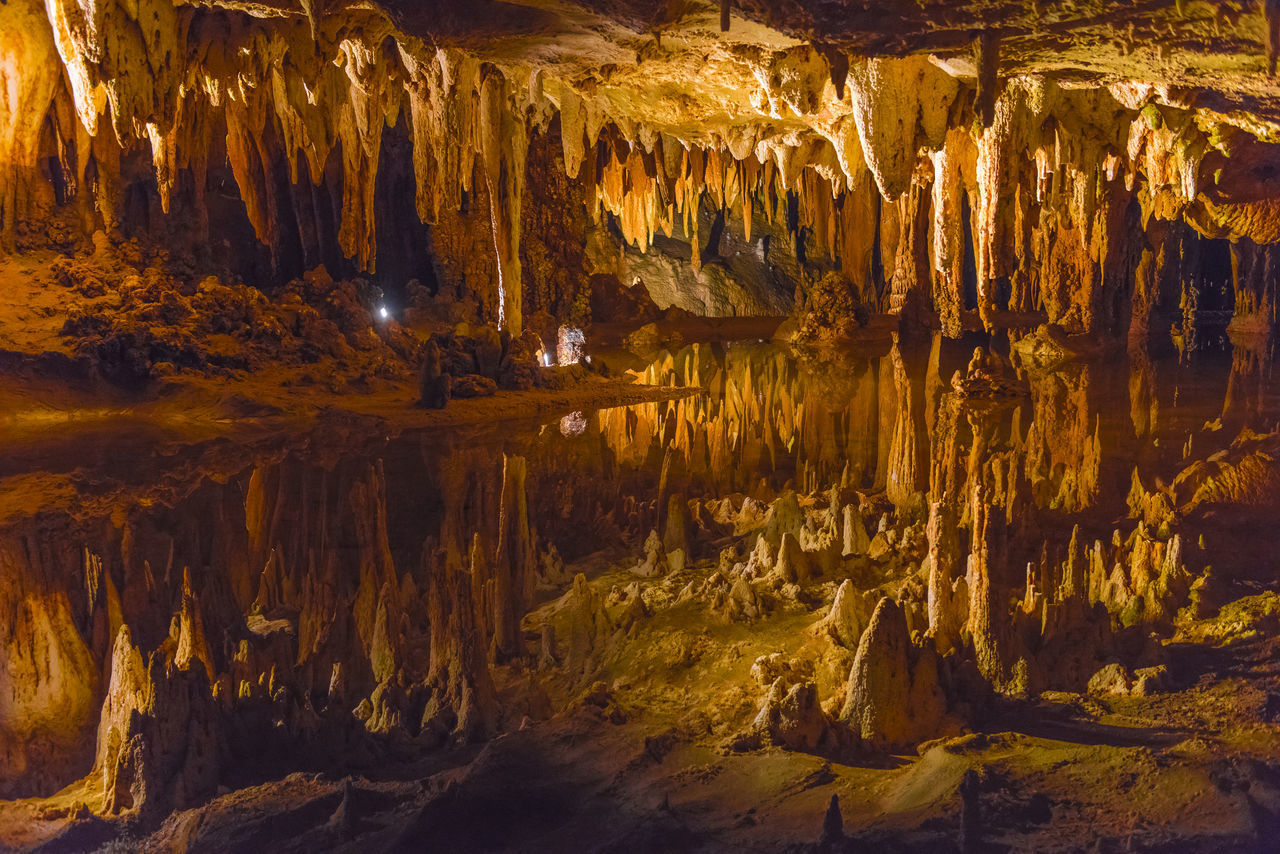 VIEW OF ILLUMINATED CAVE IN WATER