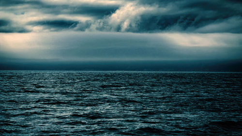 Scenic view of sea against cloudy sky