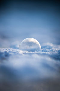 Close-up of frozen water against sky