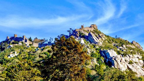 Castle on rock against blue sky