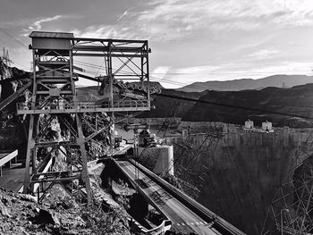 Built structure by bridge against sky