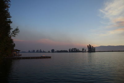 Scenic view of lake against sky during sunset