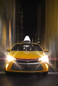 Car on illuminated street at night