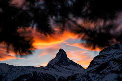 Scenic view of snowcapped mountains against sky during sunset