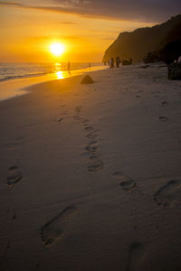 Scenic view of beach against sky during sunset