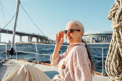 Rear view of woman on boat against sky