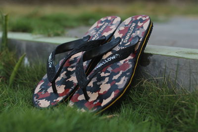 Close-up of shoes on field