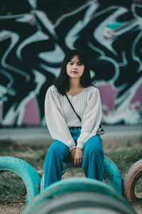 Portrait of young woman sitting on bicycle