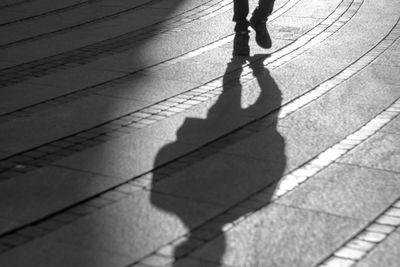 Low section of person walking on footpath