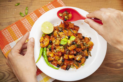Midsection of person holding food on table