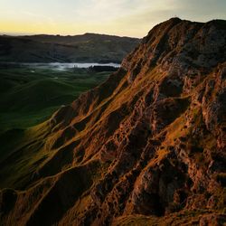 View of rocky coastline at sunset