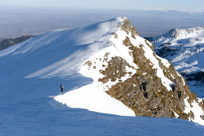 A man walking on the edge of the mountain