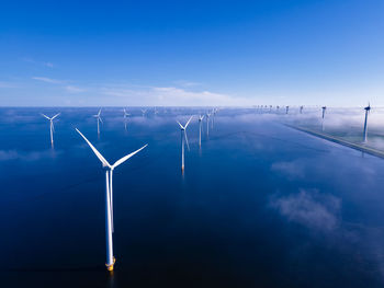 Wind turbines against blue sky