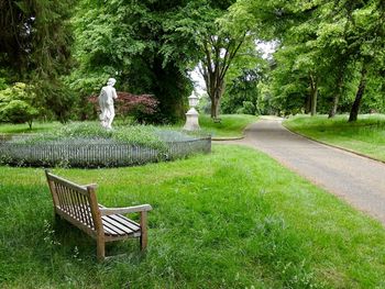 Seating, flowers and statues at waddesdon manor in the summer sunshine