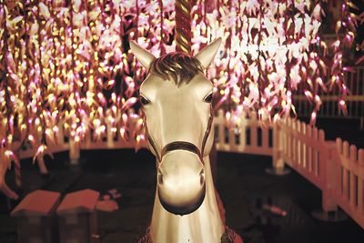 Cropped carousel horse at park