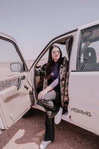 Portrait of young woman in car