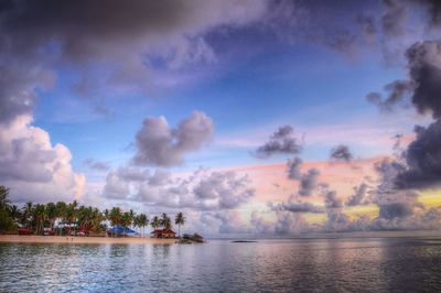 Scenic view of river against sky at sunset