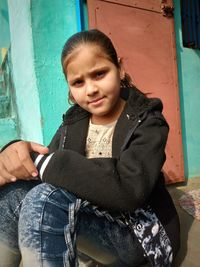 Portrait of a girl sitting outdoors