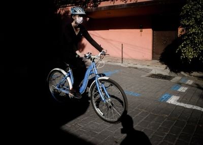 Bicycles riding bicycle on street in city