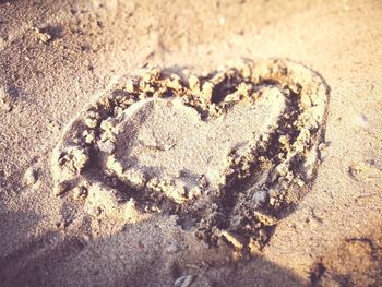 Close-up of heart shape on sand