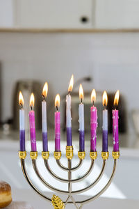 Close-up of illuminated candles on table