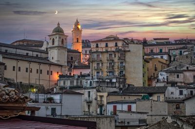 High angle view of buildings in city at sunset