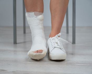 Low section of woman standing on floor