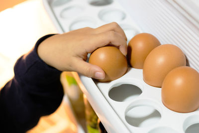 Close-up of hand holding eggs