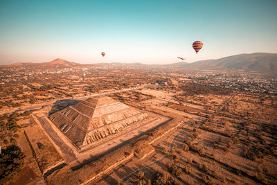 Aerial view of hot air balloon flying over landscape