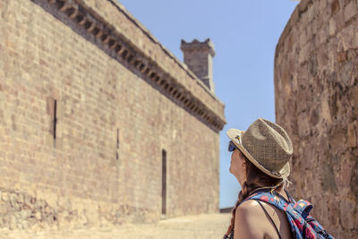 Portrait of woman against historic building