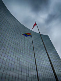 Low angle view of flag on building against sky