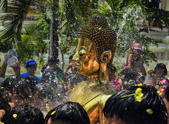 Buddha statue amidst crowd during festival