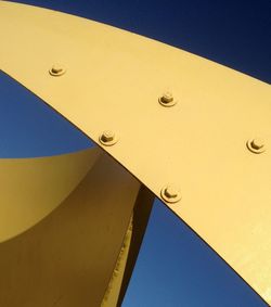 Yellow metallic structure against clear sky