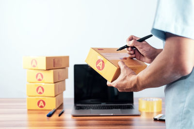 Midsection of man holding toy blocks on table