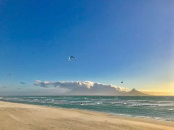 Scenic view of beach against clear blue sky