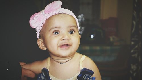 Close-up of baby girl looking away