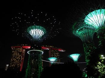 Low angle view of illuminated ferris wheel at night