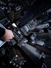 High angle view of hand holding cityscape