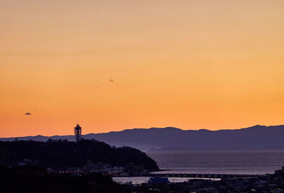 Scenic view of sea against orange sky