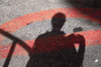 Shadow of man on road