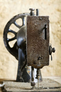 Close-up of vintage sewing machine on table in old mud house